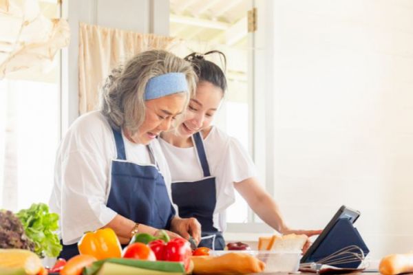 Mother and daughter cooking kidney friendly recipes for dialysis patient