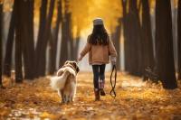 秋天小女孩牵着金毛宠物狗在公园散步摄影图(4032x2688)